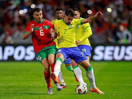 Brazil and Morocco players contesting the ball during a football match